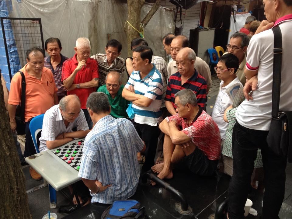 People watching a draughts game